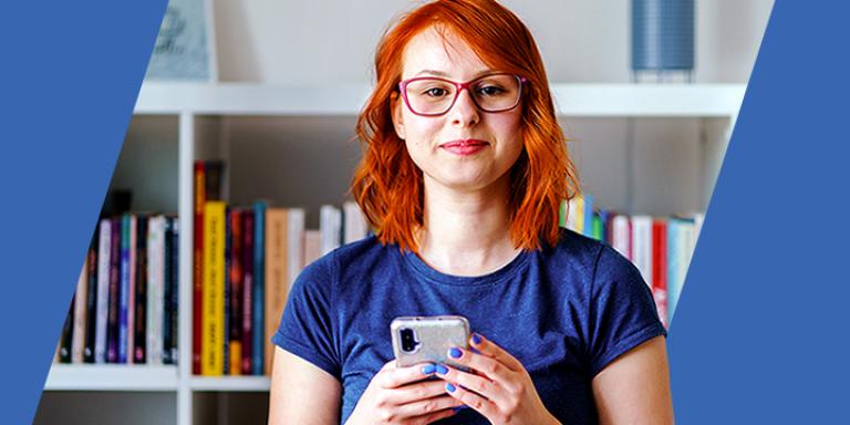 Woman with red hair holding phone.